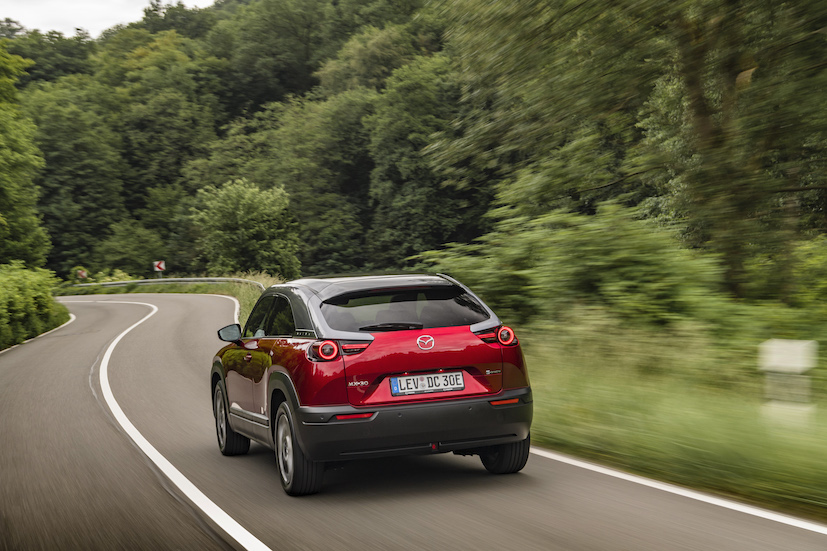 Red Mazda CX30 rear driving